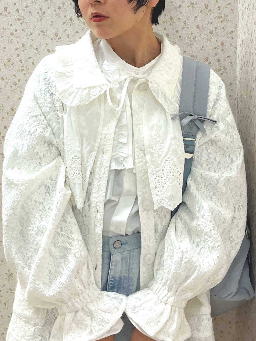 ブルー系のデニムパンツ、ホワイト系のシャツ/ブラウス、ホワイト系のテーラードジャケットを着用したレディースの冬コーディネートの7枚目の写真