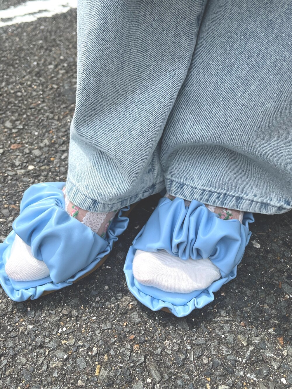 ホワイト系のジャンパースカート、ブルー系のTシャツ/カットソー、ブルー系のデニムパンツを着用したレディースの春コーディネートの10枚目の写真