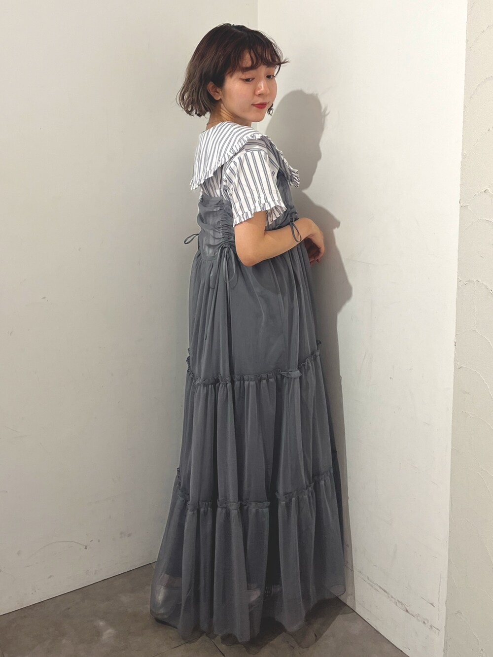 グレー系のワンピース、ホワイト系のシャツ/ブラウス、シルバー系のバレエシューズを着用したレディースの夏コーディネートの5枚目の写真