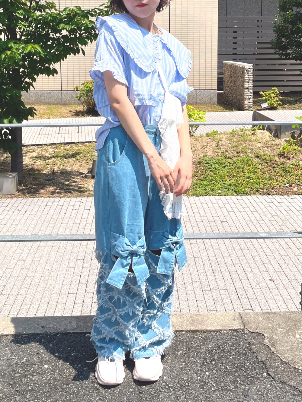 ブルー系のシャツ/ブラウス、ホワイト系のトートバッグ、ブルー系のデニムパンツを着用したレディースの夏コーディネートの7枚目の写真