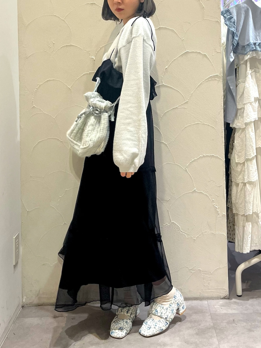 ブラック系のワンピース、ブルー系のショルダーバッグ、ホワイト系のパンプスを着用したレディースの春コーディネートの3枚目の写真