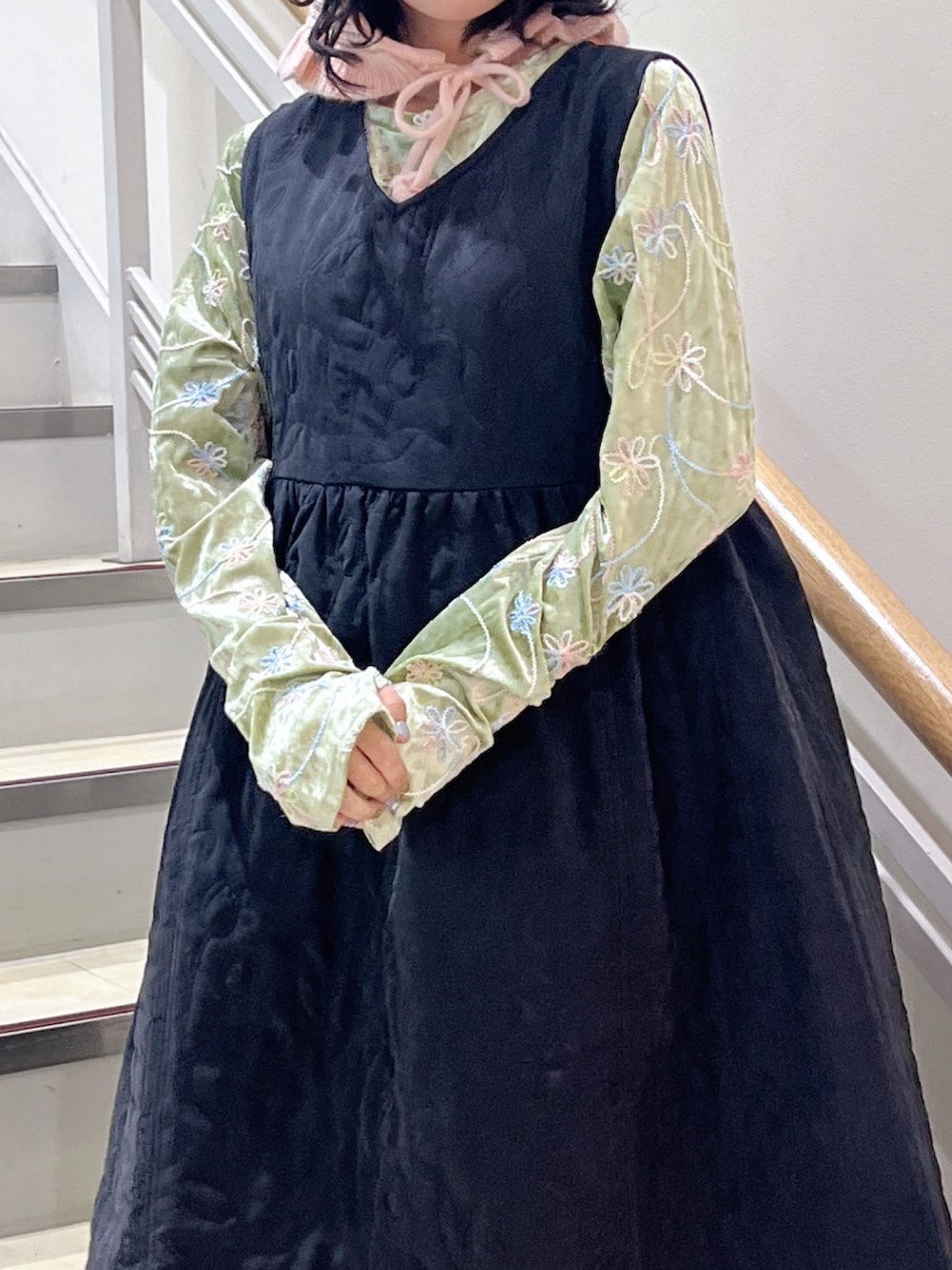 ブラック系のワンピース、ブラック系のスニーカー、グリーン系のTシャツ/カットソーを着用したレディースの秋コーディネートの2枚目の写真