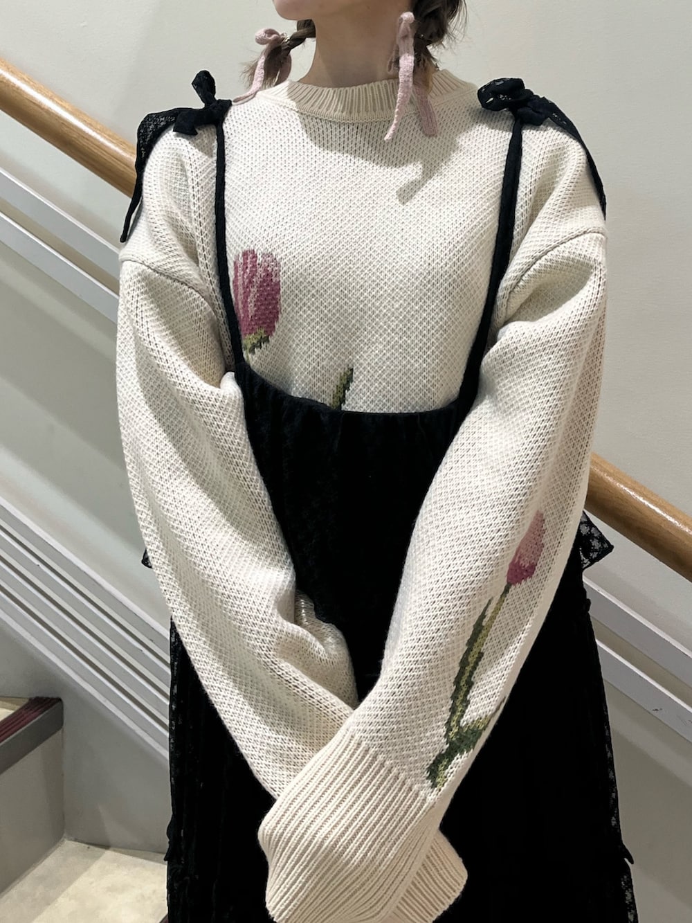 ブラック系のワンピース、ホワイト系のニット/セーター、ブラック系のパンプスを着用したレディースの冬コーディネートの4枚目の写真