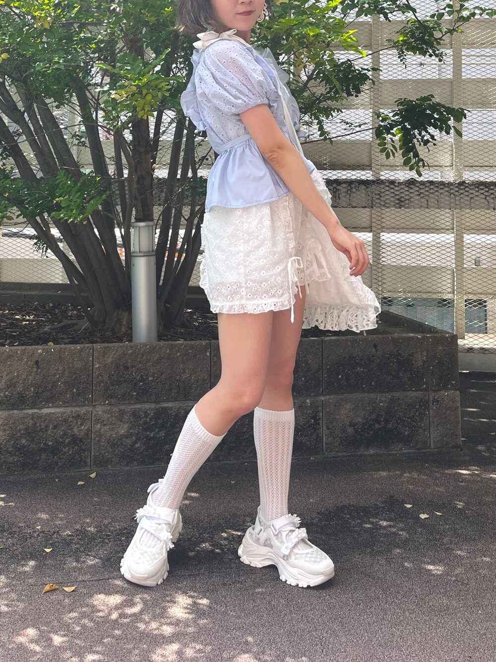 ブルー系のシャツ/ブラウス、ホワイト系のチノパンツ、ホワイト系のスニーカーを着用したレディースの夏コーディネートの3枚目の写真