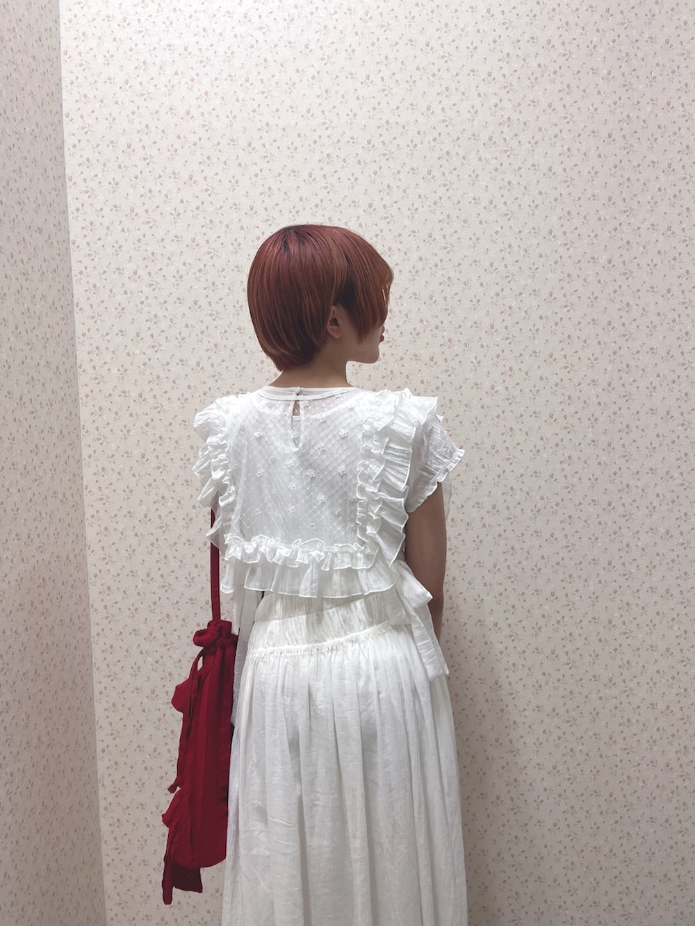 ホワイト系のワンピース、レッド系のトートバッグ、ホワイト系のスニーカーを着用したレディースの春コーディネートの7枚目の写真