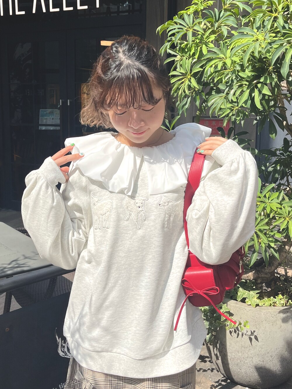 グレー系のスウェット、ホワイト系のシャツ/ブラウス、レッド系のショルダーバッグを着用したレディースの秋コーディネートの5枚目の写真