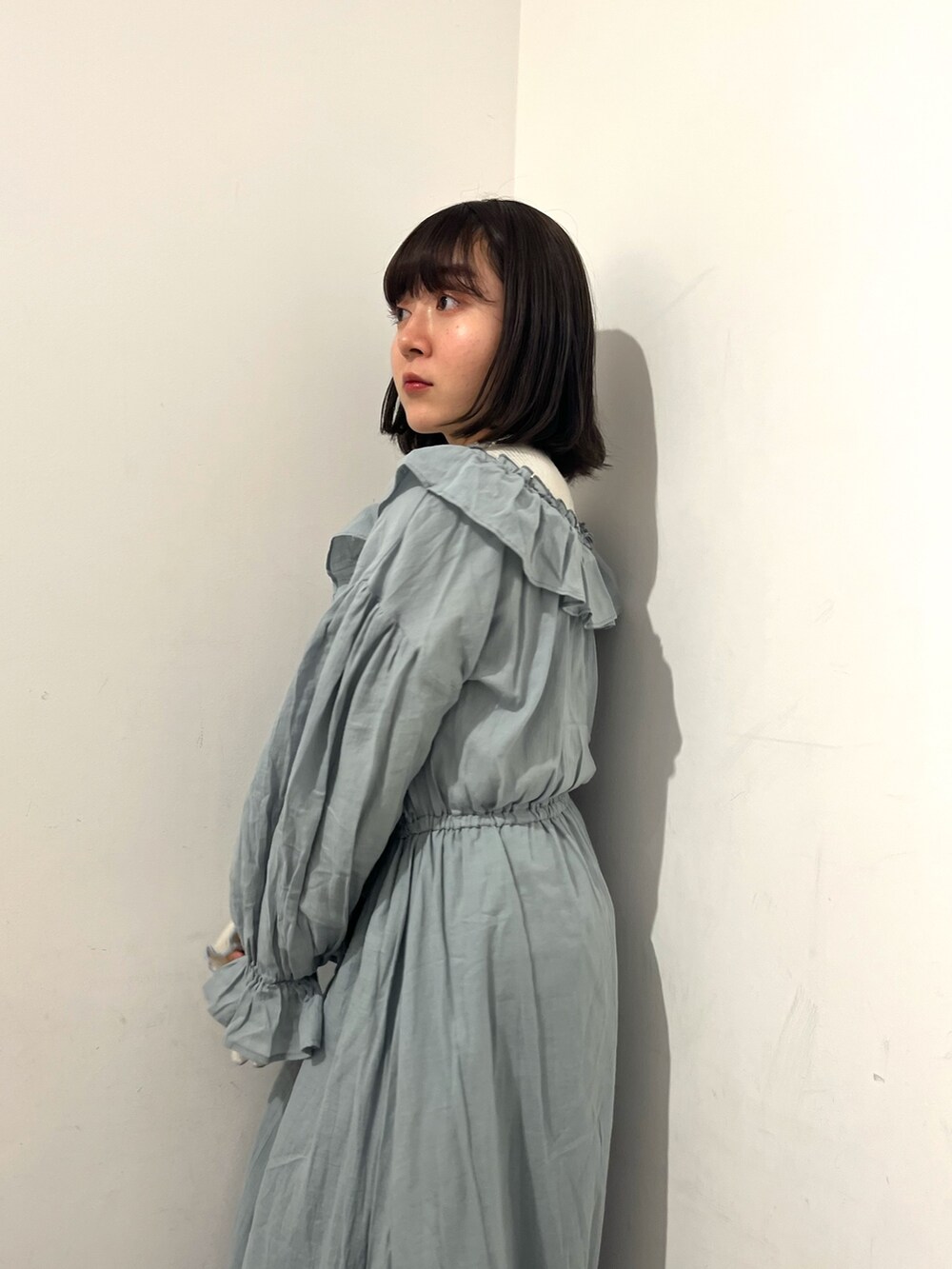 グリーン系のワンピース、ホワイト系のパンプス、ホワイト系のTシャツ/カットソーを着用したレディースの春コーディネートの7枚目の写真