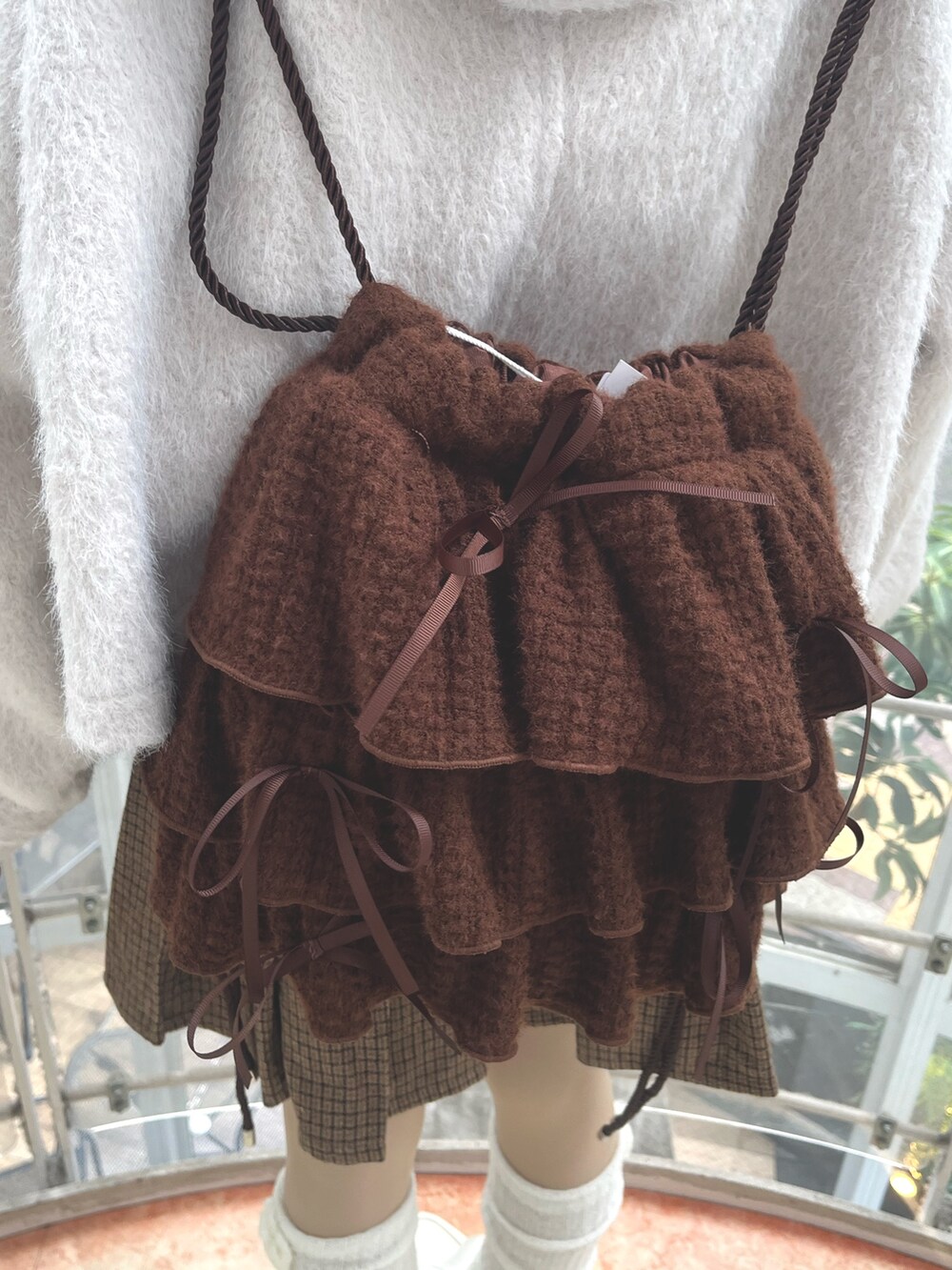 ホワイト系のニット/セーター、ホワイト系のダッフルコート、その他のスカートを着用したレディースの秋コーディネートの8枚目の写真