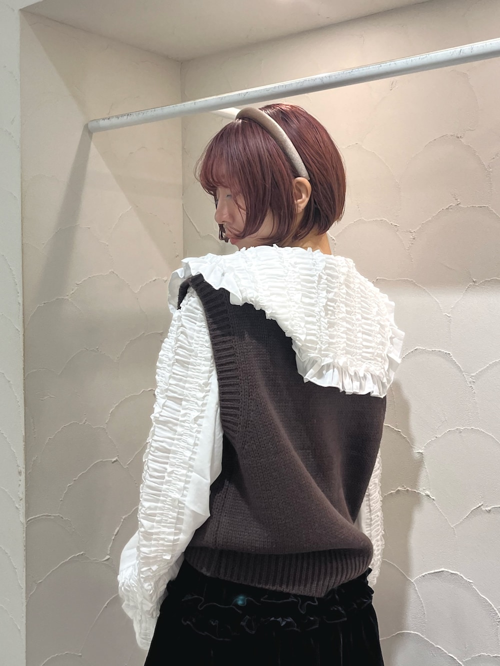 レッド系のパンプス、ブラウン系のベスト、ホワイト系のシャツ/ブラウスを着用したレディースの秋コーディネートの6枚目の写真