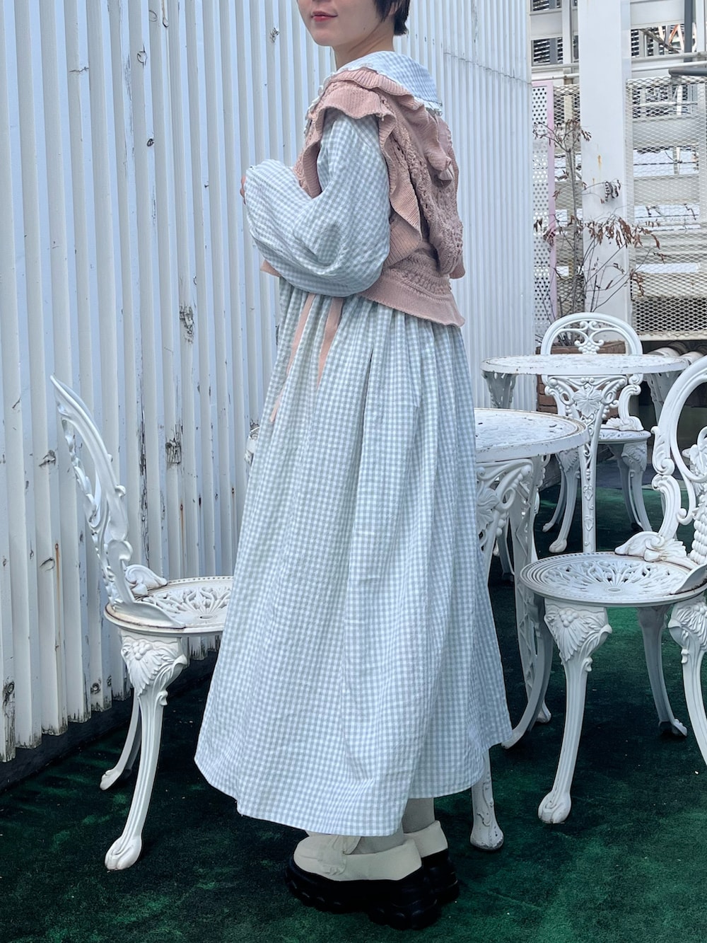 ホワイト系のローファー、グリーン系のワンピース、ピンク系のショルダーバッグを着用したレディースの冬コーディネートの5枚目の写真