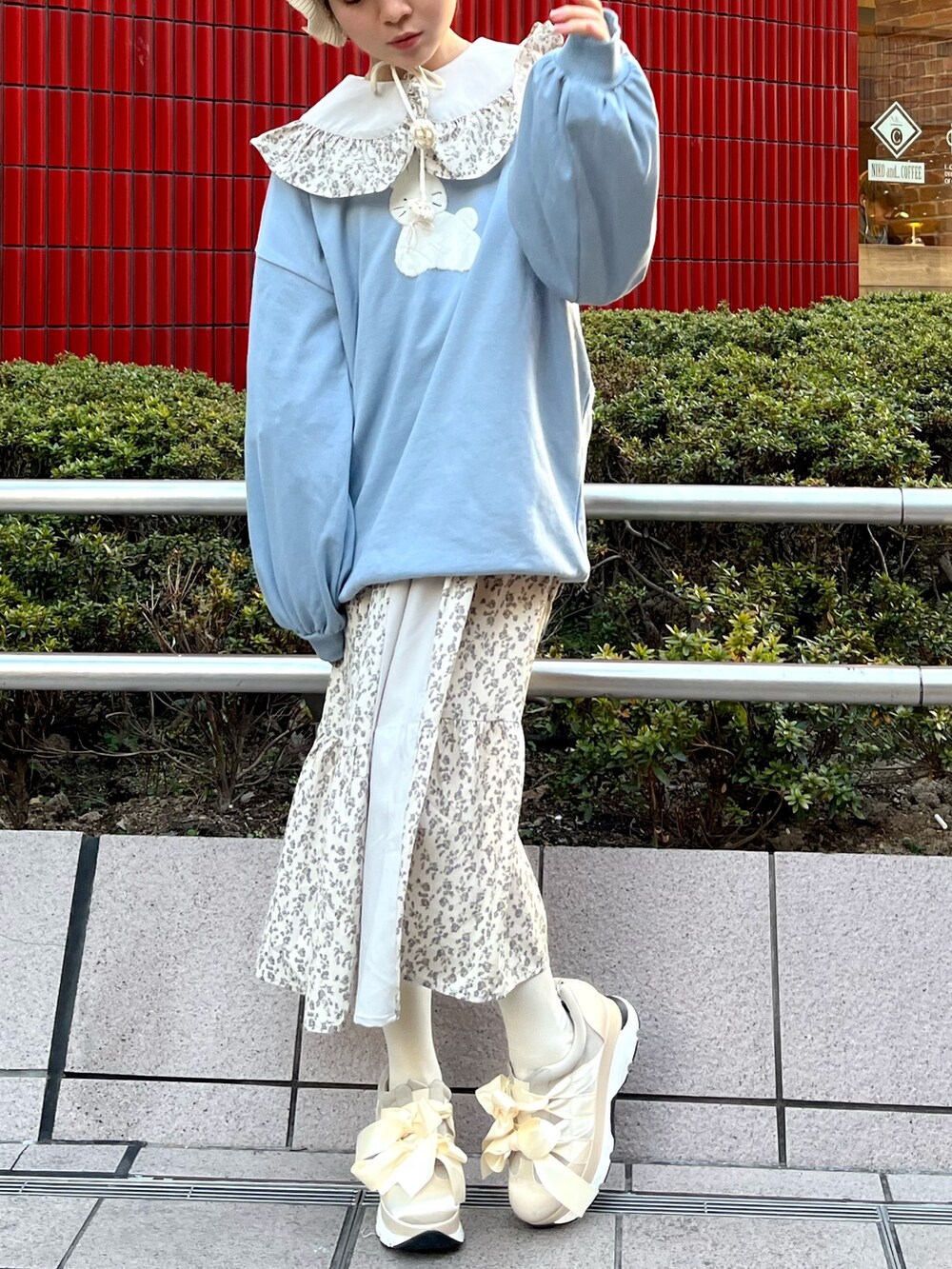 ブルー系のスウェット、ブルー系のワンピース、ホワイト系のスニーカーを着用したレディースの冬コーディネートの7枚目の写真