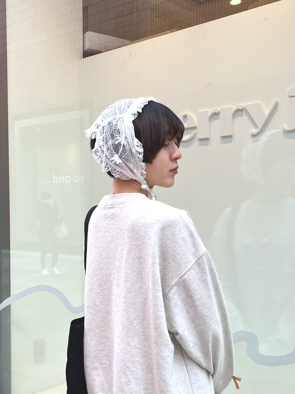 グレー系のスウェット、グレー系のスカート、ブラック系のスニーカーを着用したレディースの冬コーディネートの7枚目の写真