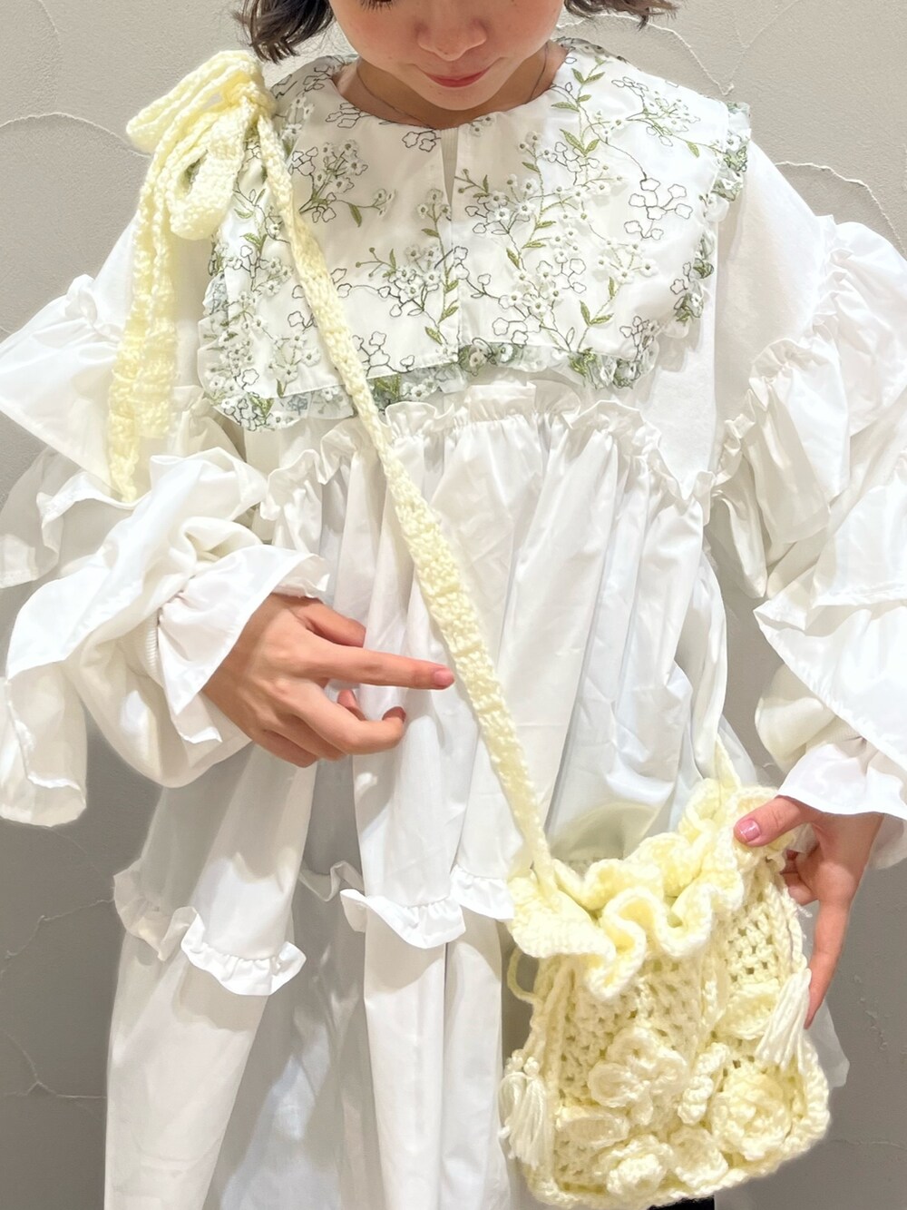 ホワイト系のシャツ/ブラウス、ホワイト系のスウェット、ホワイト系のハンドバッグを着用したレディースの冬コーディネートの4枚目の写真