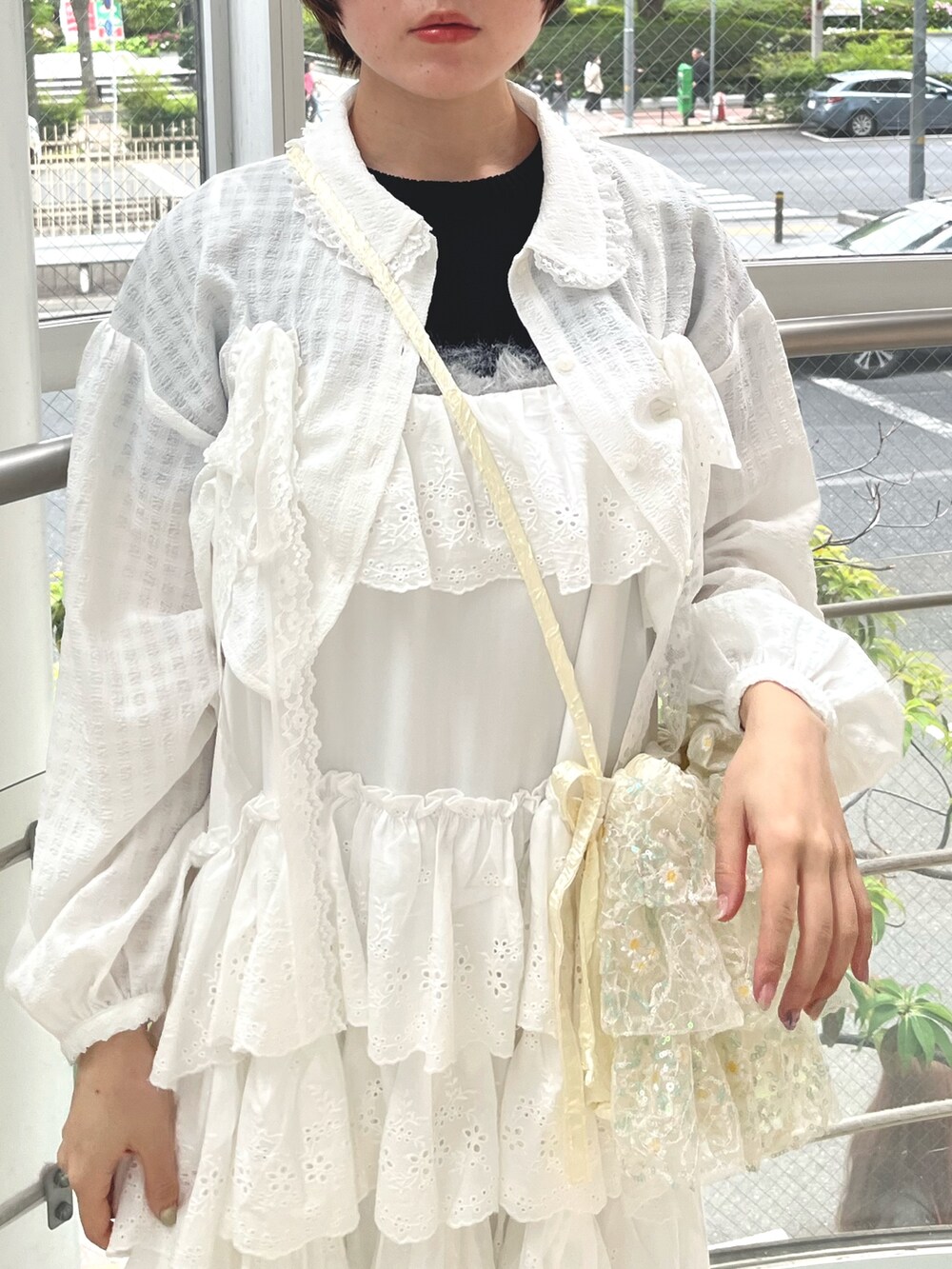 ブラック系のスニーカー、ブラック系のニット/セーター、ホワイト系のワンピースを着用したレディースの春コーディネートの5枚目の写真