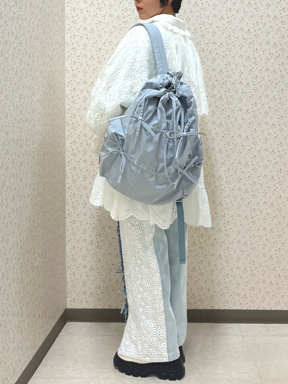 ブルー系のデニムパンツ、ホワイト系のシャツ/ブラウス、ホワイト系のテーラードジャケットを着用したレディースの冬コーディネートの3枚目の写真