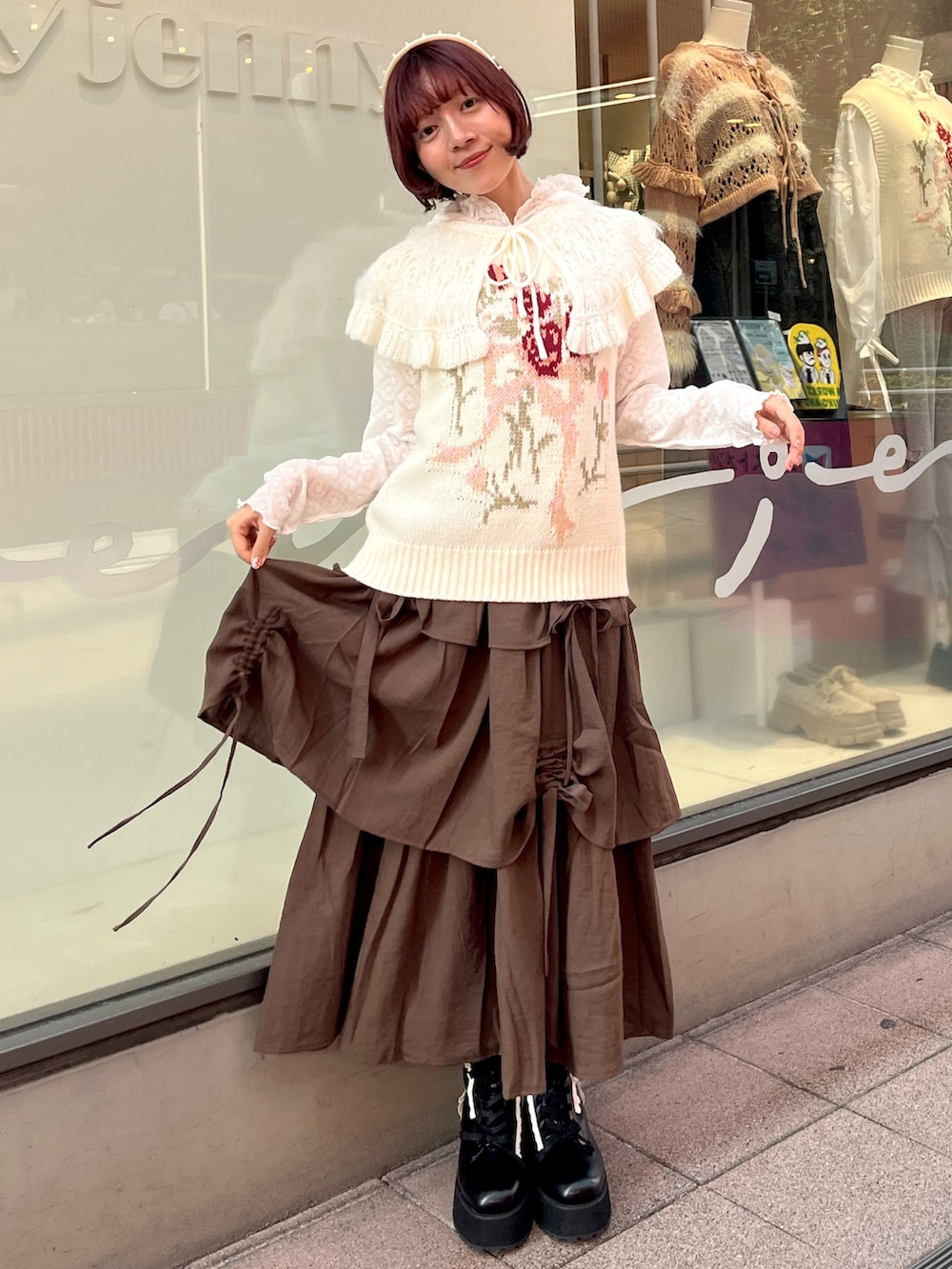 ホワイト系のベスト、ホワイト系のTシャツ/カットソー、ブラウン系のスカートを着用したレディースの秋コーディネートの5枚目の写真