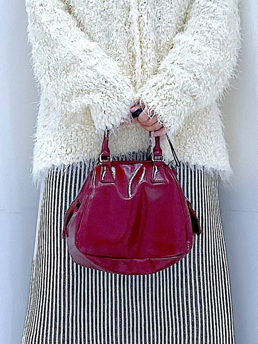 ブラック系のブーツ、ベージュ系のスカート、ベージュ系のカーディガン/ボレロを着用したレディースの秋コーディネートの9枚目の写真