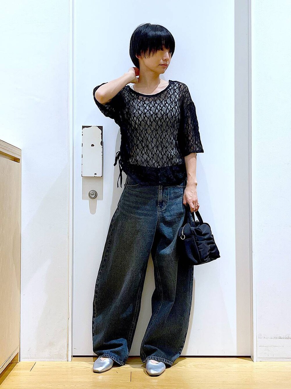 ブルー系のデニムパンツ、シルバー系のパンプス、ブラック系のTシャツ/カットソーを着用したレディースの夏コーディネートの2枚目の写真