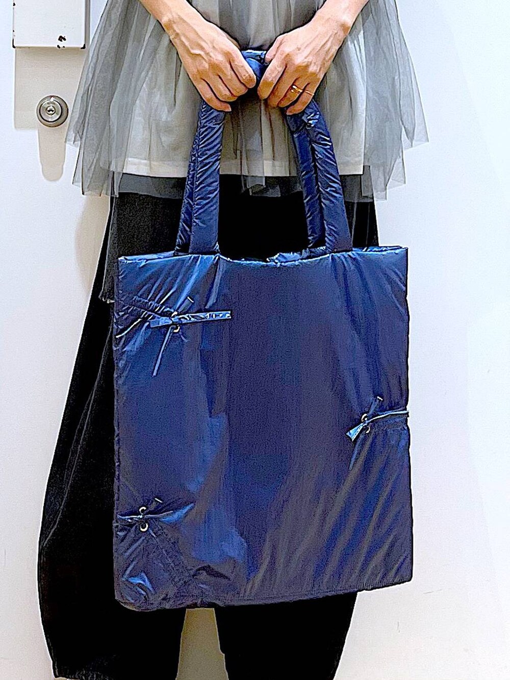 グレー系のTシャツ/カットソー、ブラック系のデニムパンツ、ブルー系のトートバッグを着用したレディースの秋コーディネートの9枚目の写真