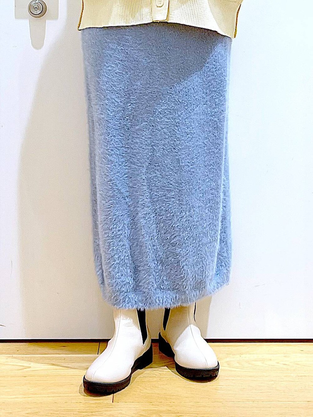 ベージュ系のブーツ、ベージュ系のニット/セーター、ベージュ系のショルダーバッグを着用したレディースの冬コーディネートの8枚目の写真