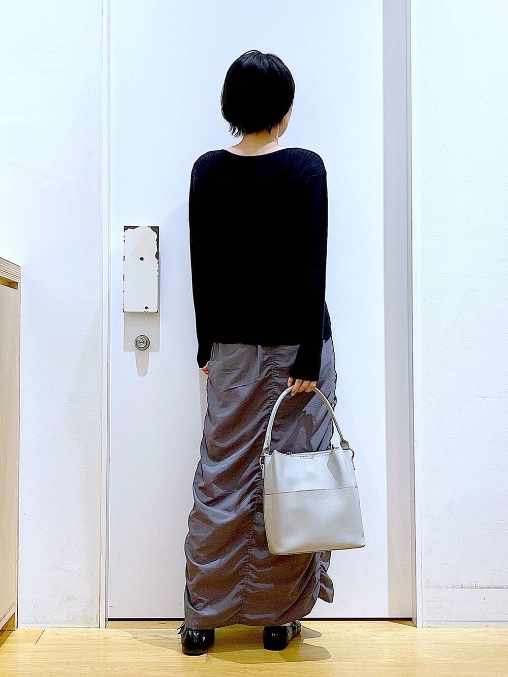 ブラック系のパンプス、ブラック系のカーディガン/ボレロ、グレー系のショルダーバッグを着用したレディースの秋コーディネートの5枚目の写真