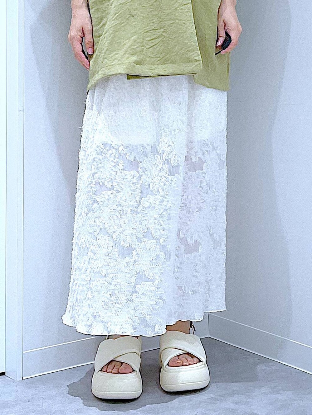 シルバー系のショルダーバッグ、ホワイト系のサンダル、グリーン系のテーラードジャケットを着用したレディースの夏コーディネートの8枚目の写真