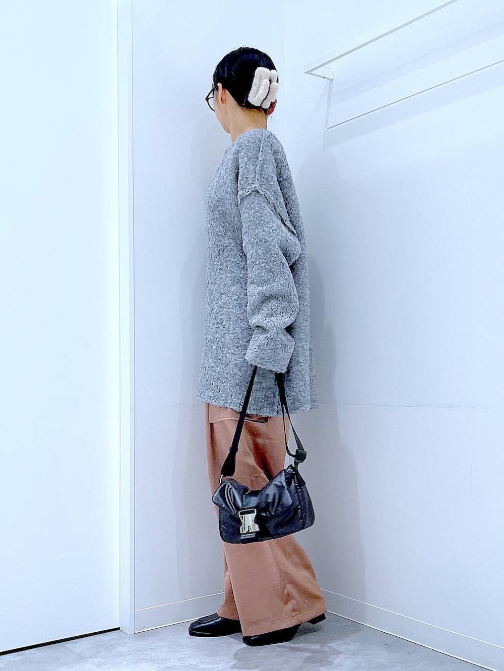 ブラック系のブーツ、グレー系のニット/セーター、ピンク系のカーゴパンツを着用したレディースの冬コーディネートの3枚目の写真