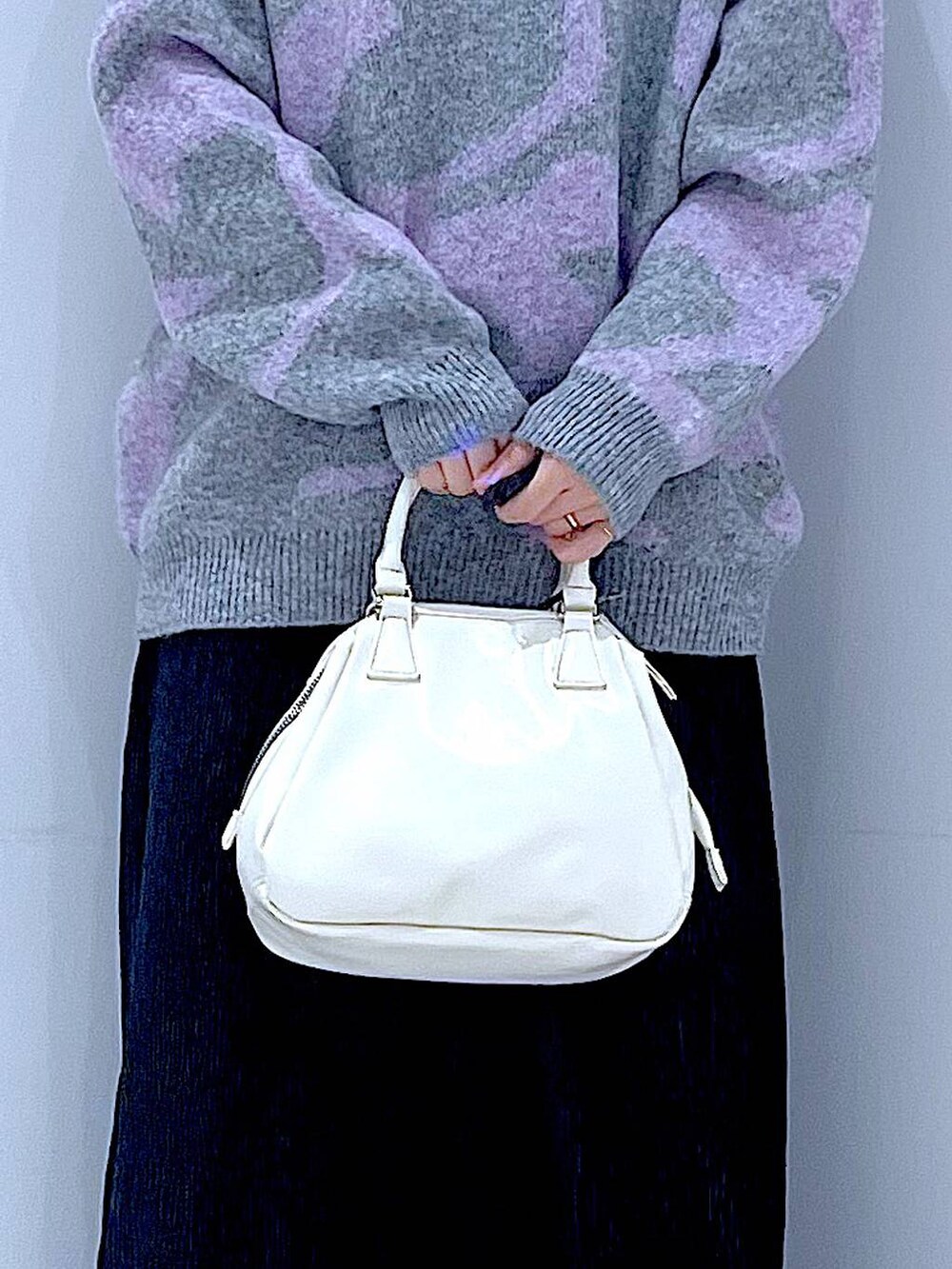 ブラック系のブーツ、グレー系のニット/セーター、ブラック系のスカートを着用したレディースの冬コーディネートの9枚目の写真