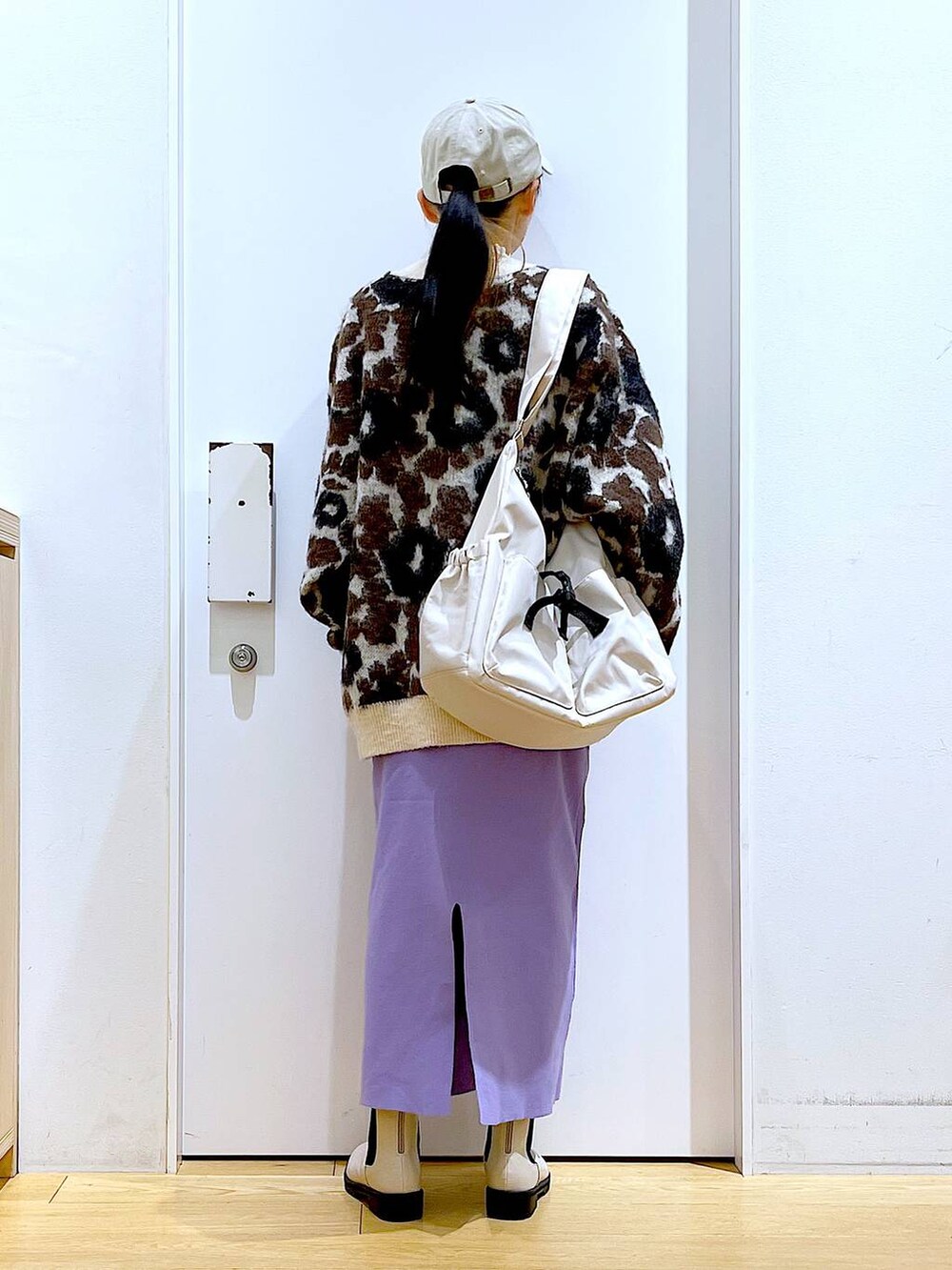 ホワイト系のTシャツ/カットソー、ベージュ系のブーツ、ベージュ系のショルダーバッグを着用したレディースの冬コーディネートの5枚目の写真