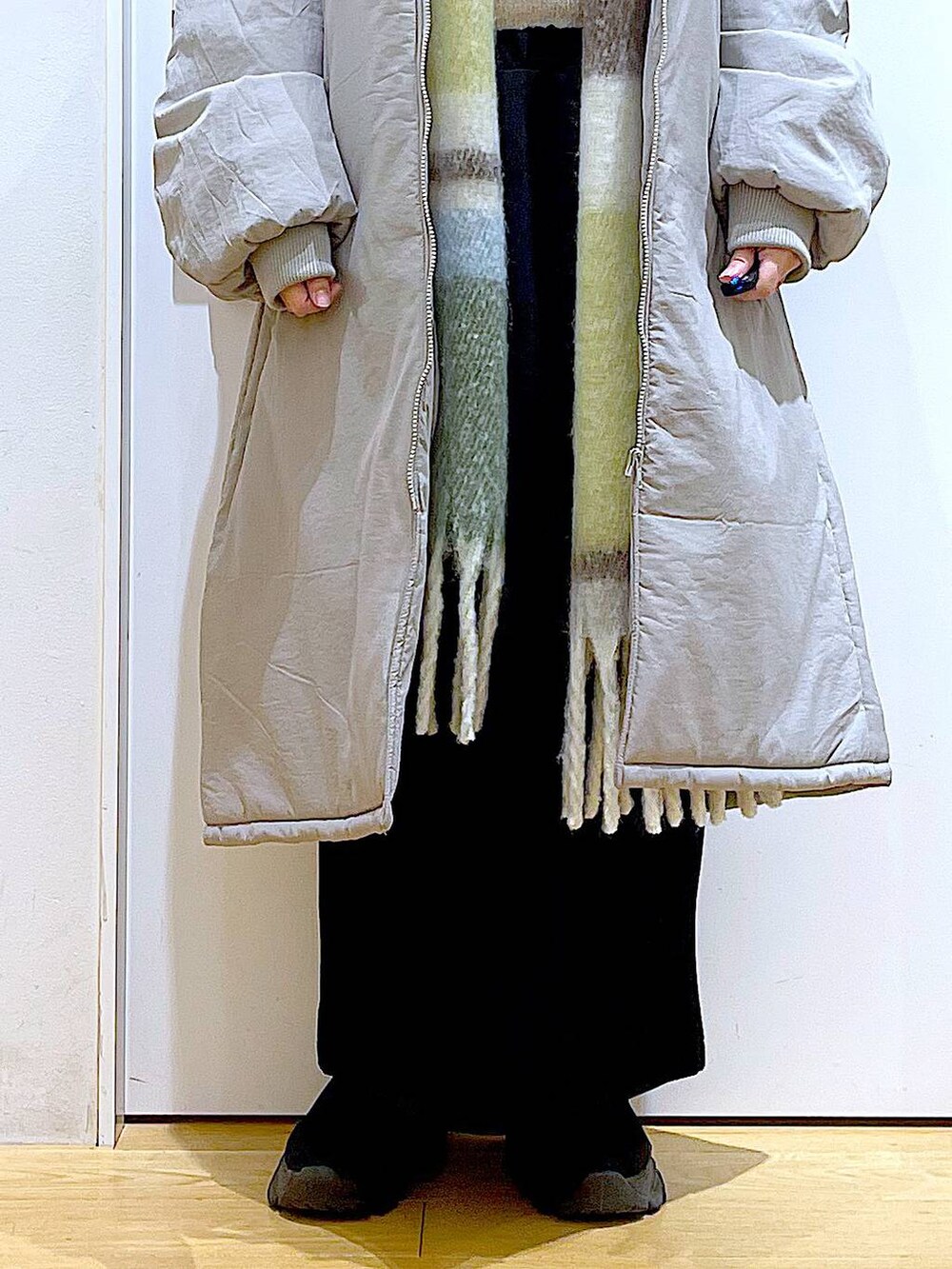 グレー系のミリタリージャケット、ブラック系のブーツ、ブラック系のショルダーバッグを着用したレディースの冬コーディネートの8枚目の写真