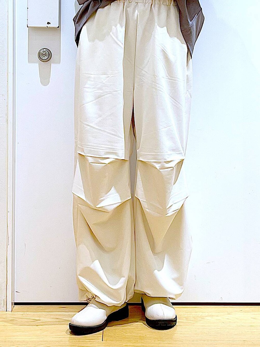 ベージュ系のその他パンツ、ベージュ系のブーツ、ブラック系のショルダーバッグを着用したレディースの春コーディネートの8枚目の写真