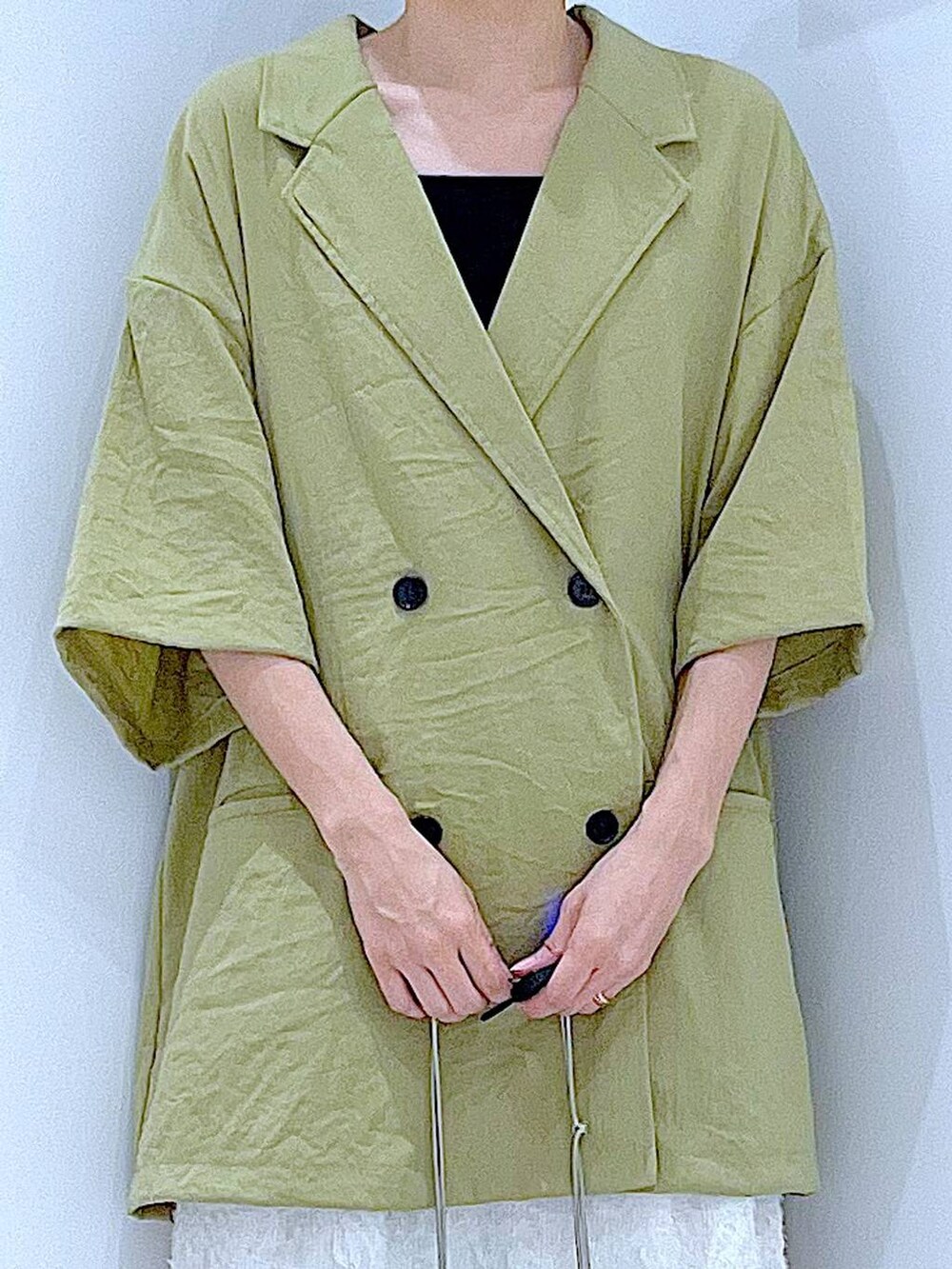 シルバー系のショルダーバッグ、ホワイト系のサンダル、グリーン系のテーラードジャケットを着用したレディースの夏コーディネートの7枚目の写真