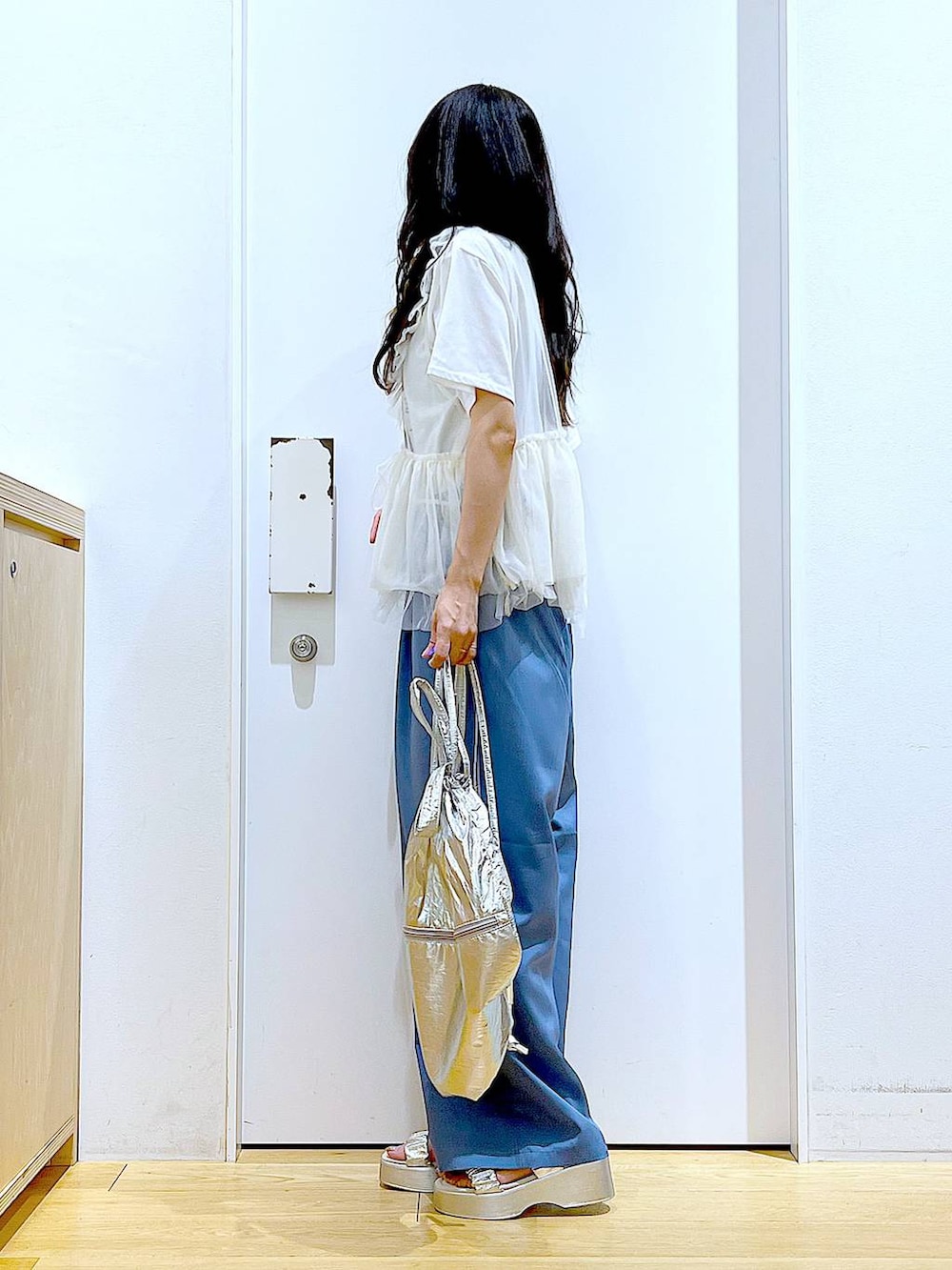 シルバー系のバックパック/リュック、ホワイト系のTシャツ/カットソー、シルバー系のサンダルを着用したレディースの夏コーディネートの3枚目の写真