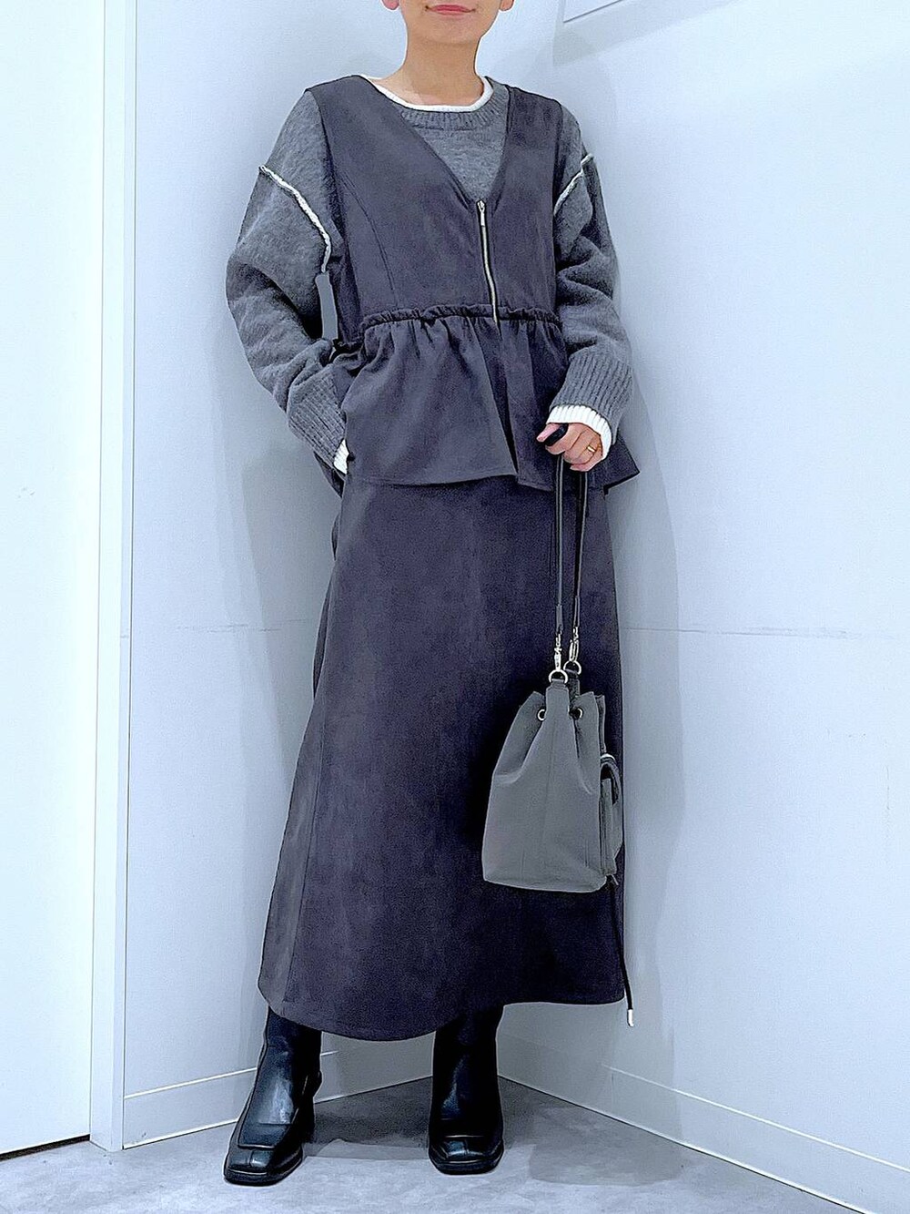 ブラック系のブーツ、グレー系のワンピース、グレー系のニット/セーターを着用したレディースの冬コーディネートの6枚目の写真