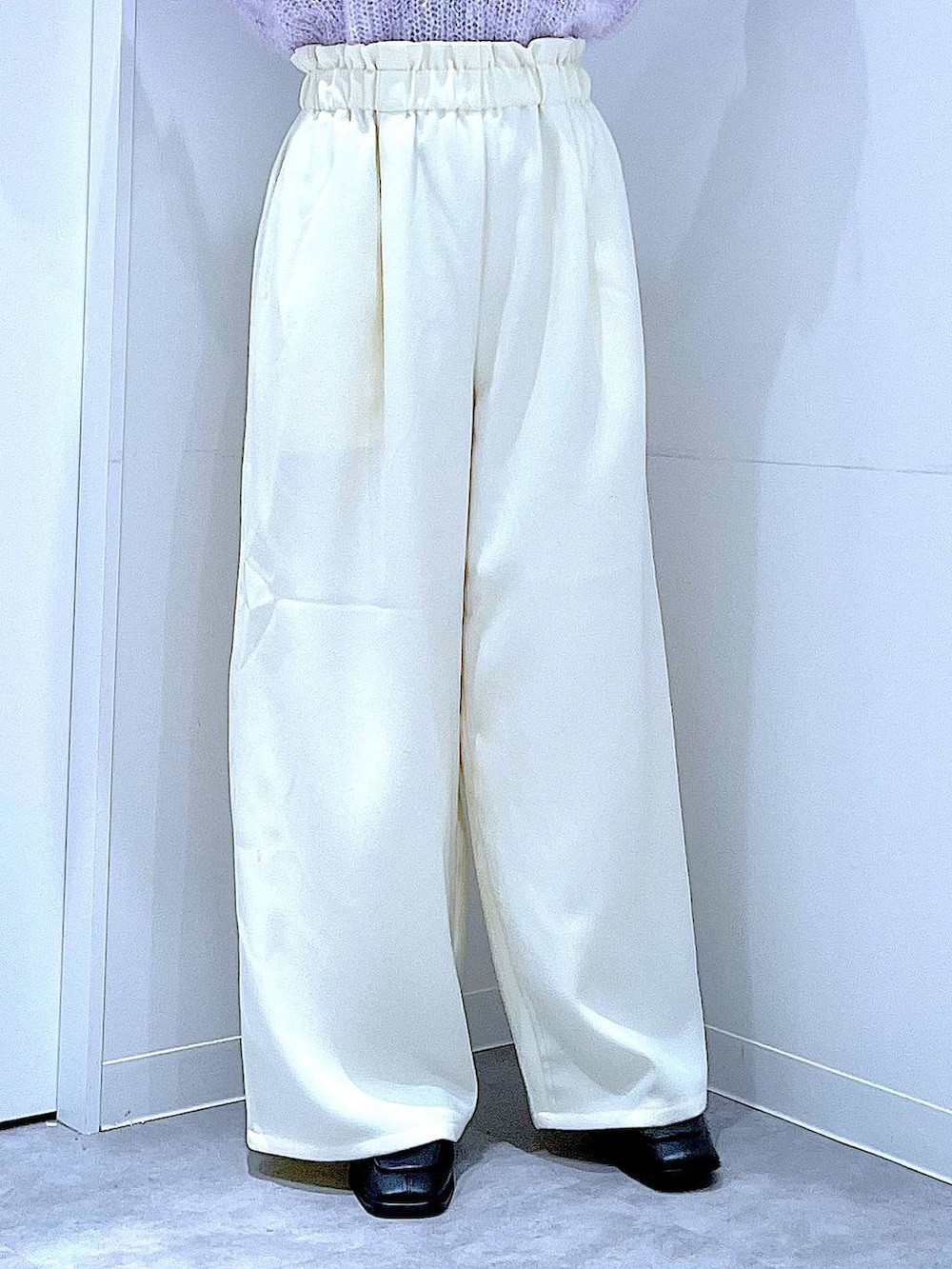 ブラック系のブーツ、ホワイト系のショルダーバッグ、パープル系のニット/セーターを着用したレディースの冬コーディネートの8枚目の写真