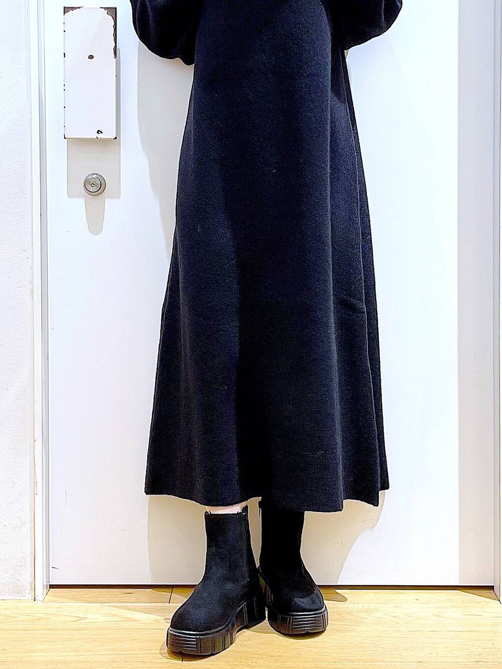 ブラック系のブーツ、ブラック系のワンピース、その他のポーチを着用したレディースの冬コーディネートの8枚目の写真