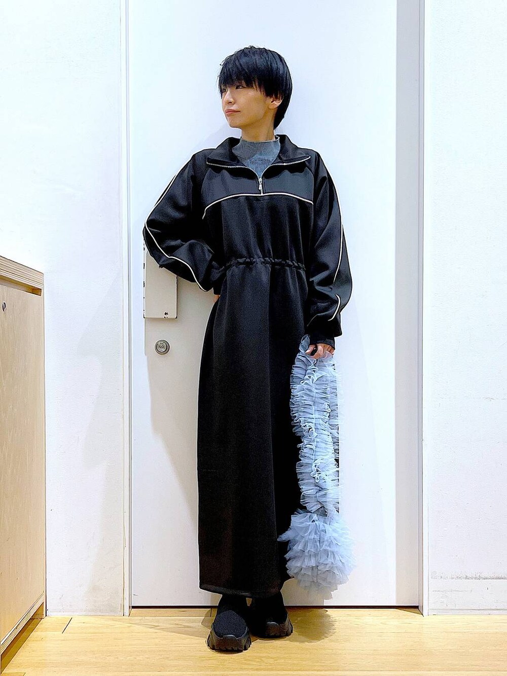 ブラック系のブーツ、ブルー系のショルダーバッグ、ブルー系のニット/セーターを着用したレディースの冬コーディネートの2枚目の写真