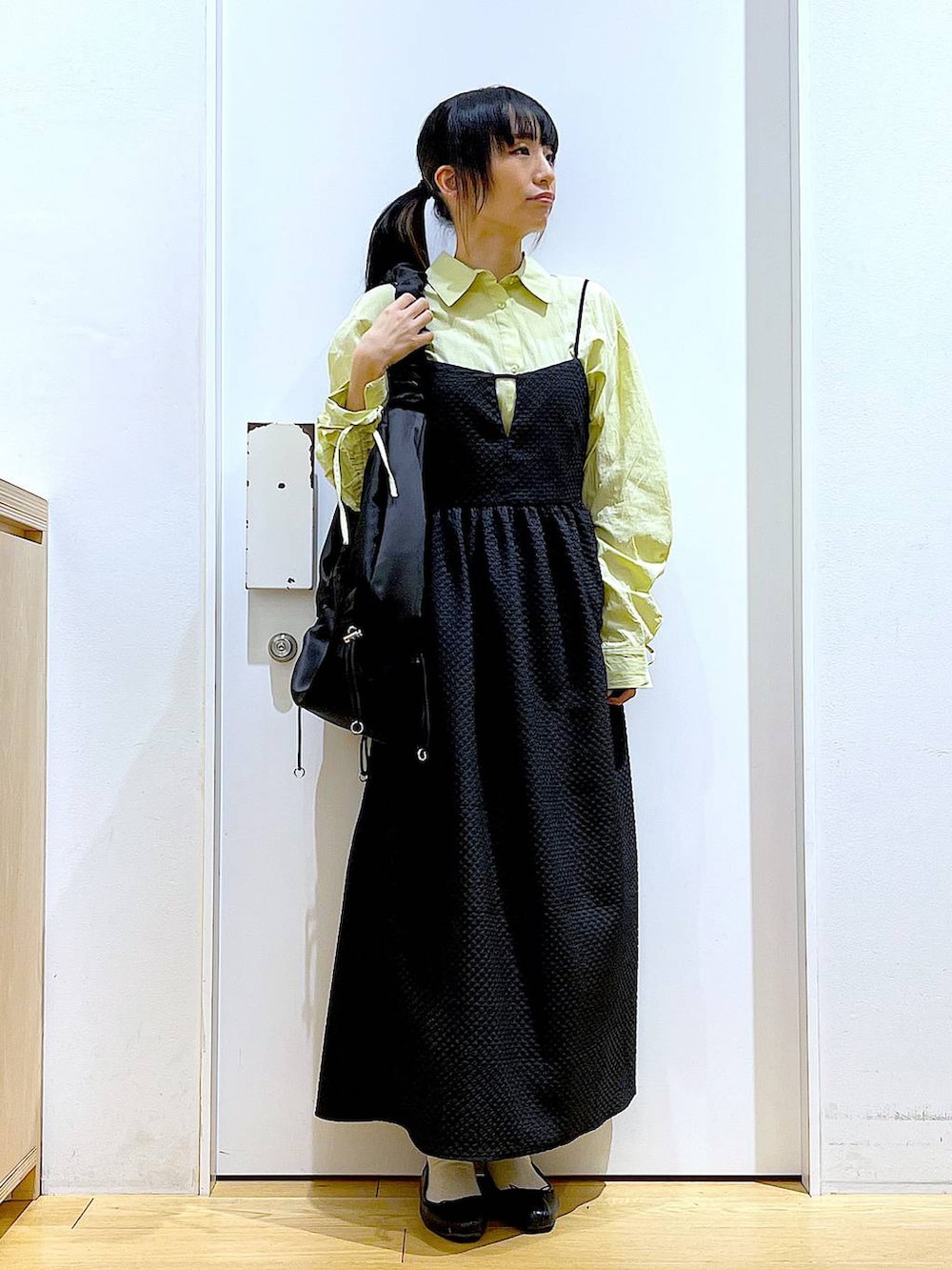 グリーン系のシャツ/ブラウス、ブラック系のバレエシューズ、ブラック系のショルダーバッグを着用したレディースの春コーディネートの2枚目の写真