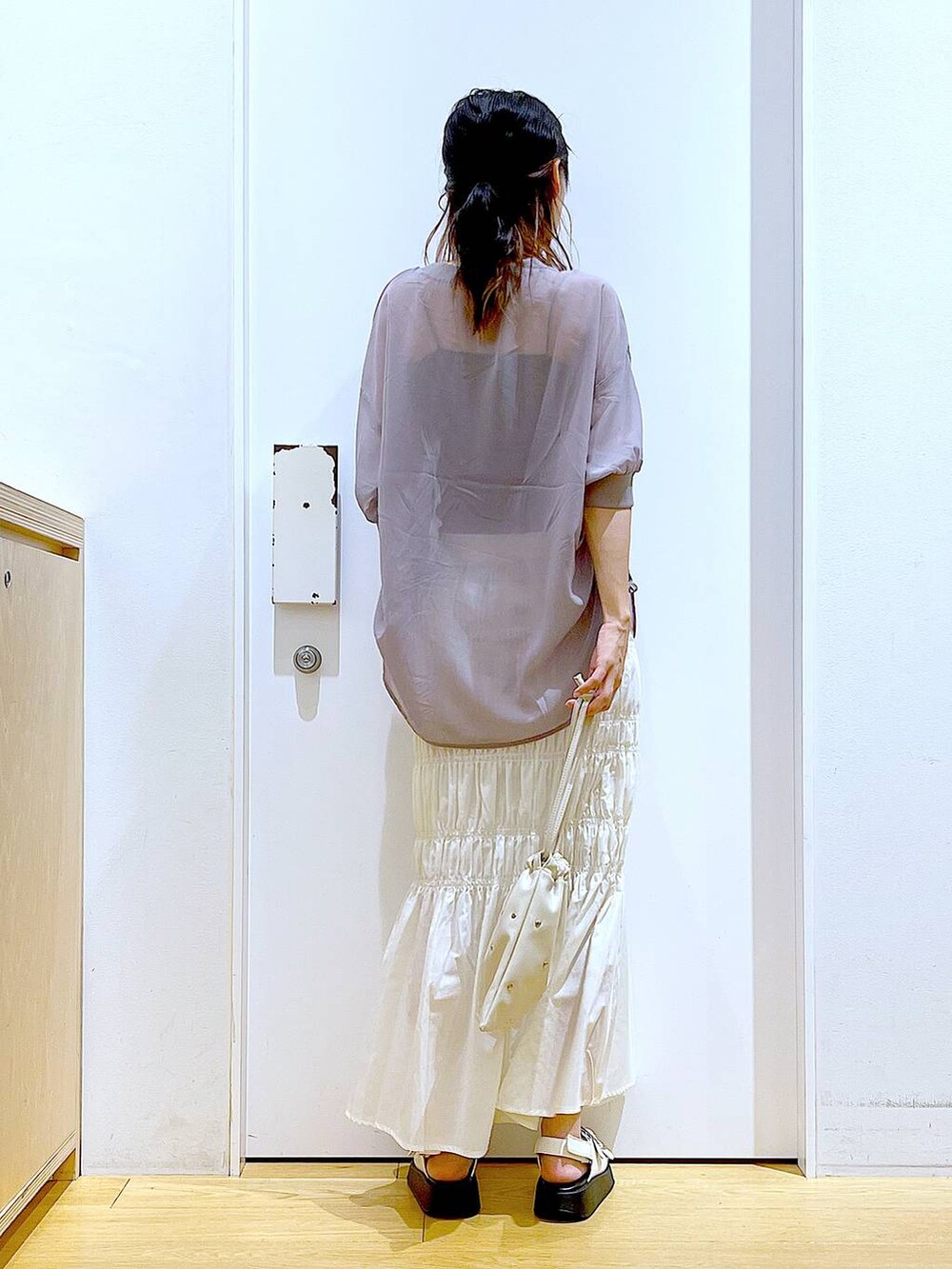 ホワイト系のサンダル、ホワイト系のショルダーバッグ、ホワイト系のスカートを着用したレディースの夏コーディネートの5枚目の写真