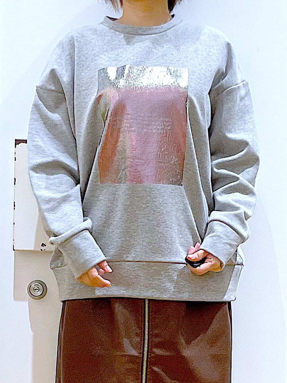 ブラウン系のスカート、ブラック系のショルダーバッグ、ブラック系のブーツを着用したレディースの冬コーディネートの7枚目の写真