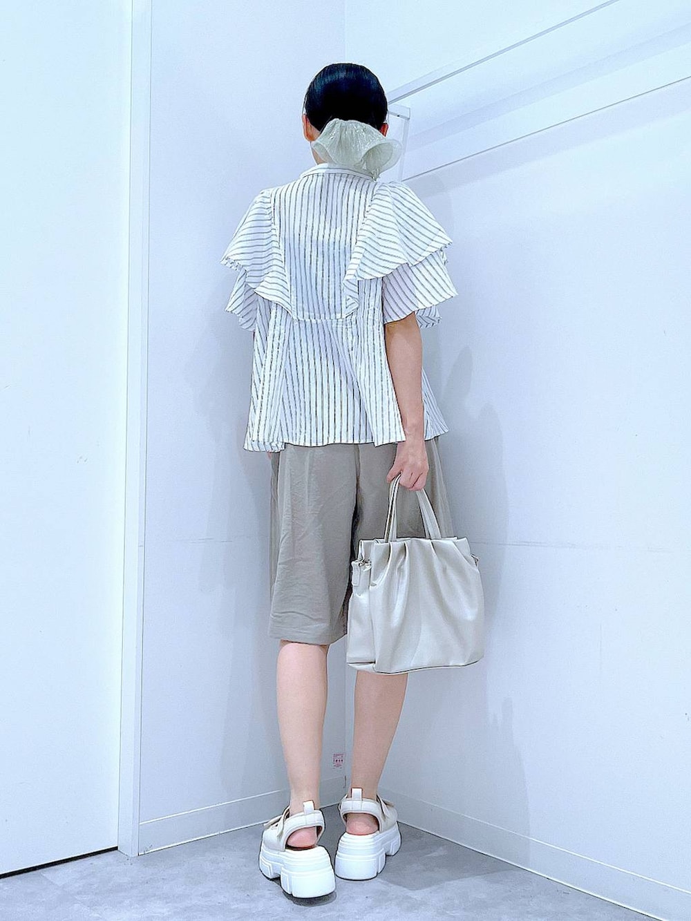 ホワイト系のサンダル、ベージュ系のその他パンツ、ホワイト系のハンドバッグを着用したレディースの夏コーディネートの5枚目の写真