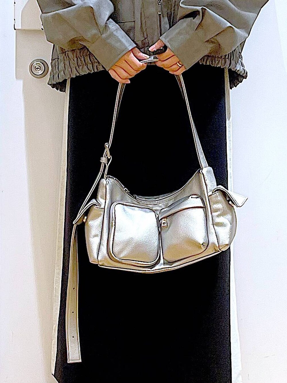 ブラック系のスカート、グレー系のブルゾン、ブラック系のブーツを着用したレディースの冬コーディネートの9枚目の写真