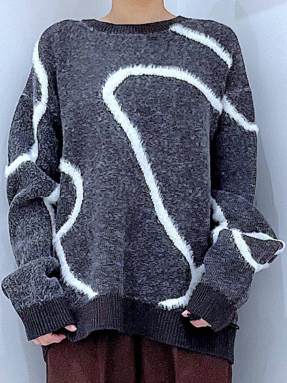 ブラック系のブーツ、ブラウン系のスラックス、ブラック系のショルダーバッグを着用したレディースの冬コーディネートの7枚目の写真