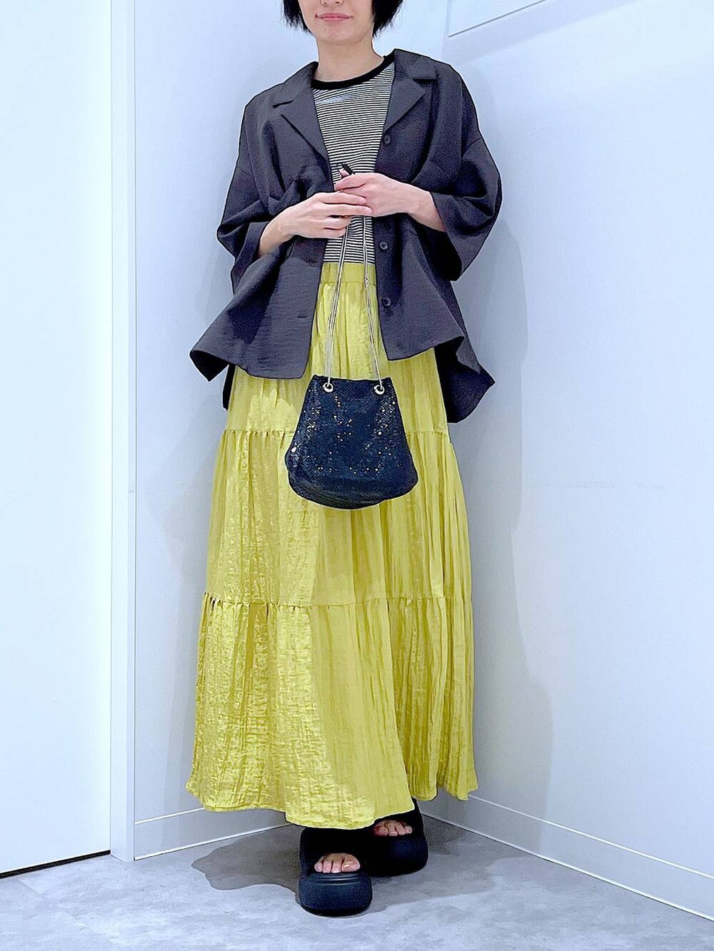 ブラック系のショルダーバッグ、その他のTシャツ/カットソー、ブラック系のサンダルを着用したレディースの夏コーディネートの6枚目の写真