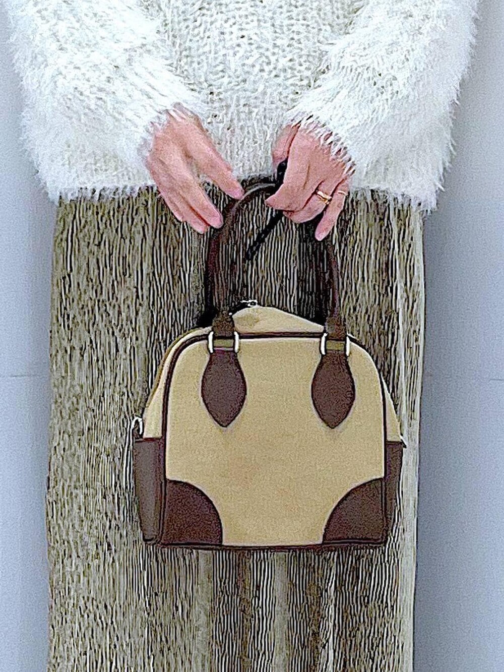 ベージュ系のハンドバッグ、ブラック系のブーツ、ベージュ系のニット/セーターを着用したレディースの冬コーディネートの9枚目の写真