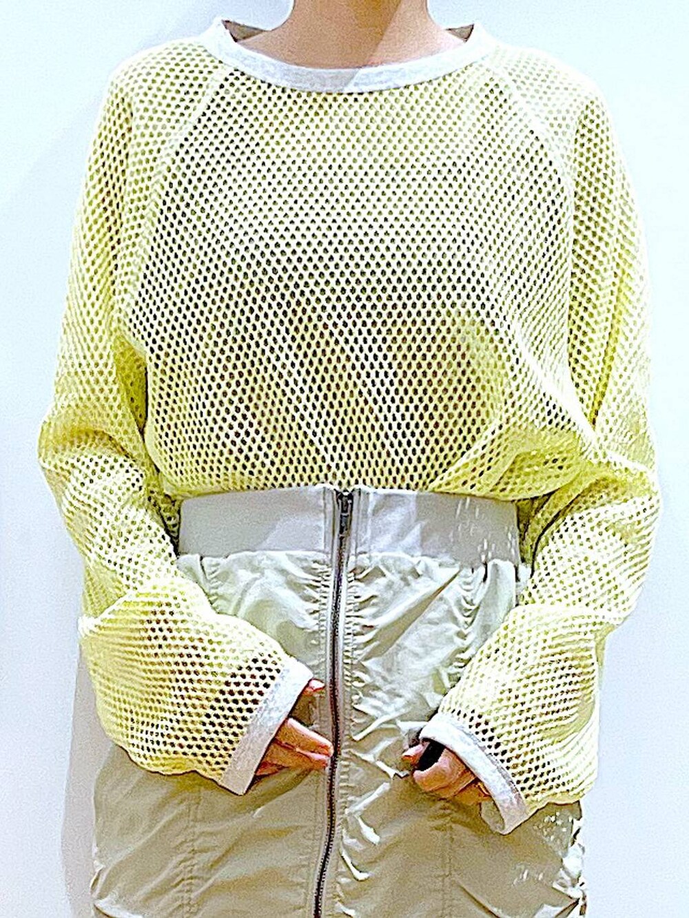 ベージュ系のスカート、ブラック系のバックパック/リュック、イエロー系のTシャツ/カットソーを着用したレディースの春コーディネートの7枚目の写真