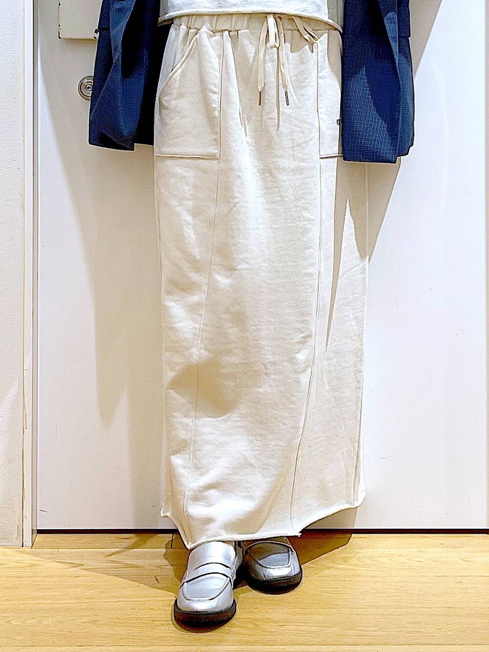 シルバー系のローファー、シルバー系のショルダーバッグ、ベージュ系のスウェットを着用したレディースの春コーディネートの8枚目の写真