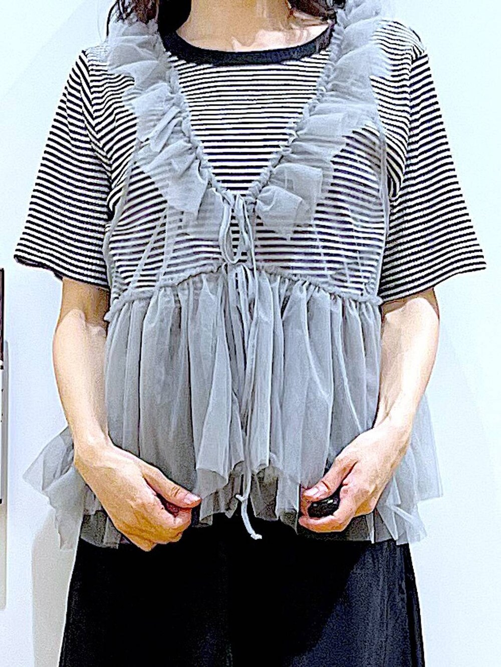 ホワイト系のショルダーバッグ、ホワイト系のサンダル、ブラック系のスカートを着用したレディースの夏コーディネートの7枚目の写真