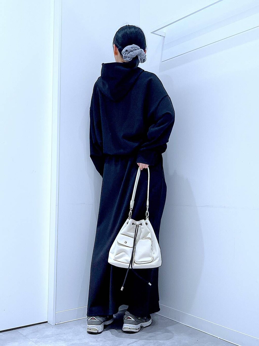 ベージュ系のショルダーバッグ、ブラック系のスウェット、ブラック系のスカートを着用したレディースの春コーディネートの5枚目の写真