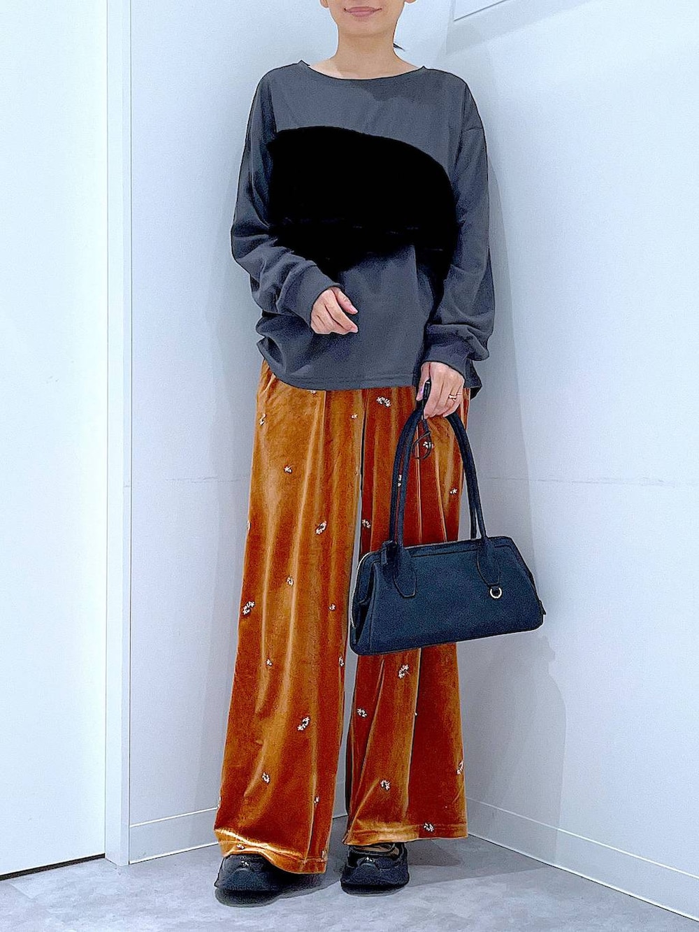 ブラック系のローファー、ブラック系のハンドバッグ、オレンジ系のその他パンツを着用したレディースの秋コーディネートの6枚目の写真